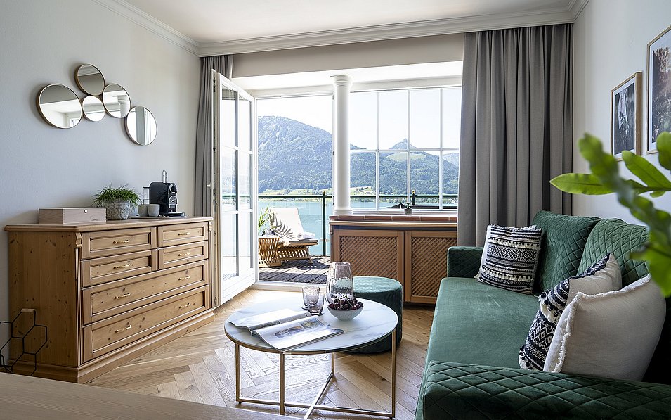 Ein Zimmer mit Tisch und Sofa im Hotel Peter St. Wolfgang.